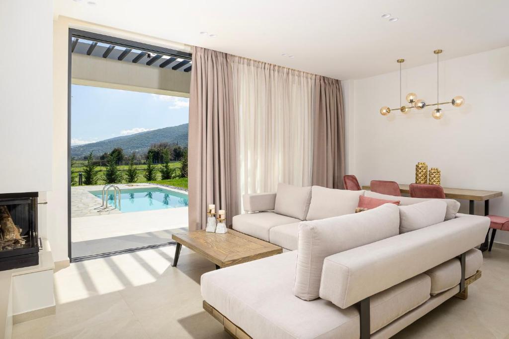 a living room with a couch and a fireplace at Ioannina Secret Luxury Villas in Ioannina