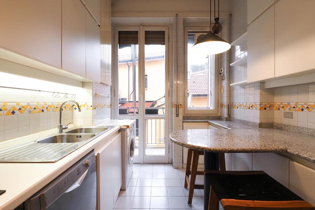 a kitchen with a sink and a counter top at HomNest I S.Ambrogio Elegant Apt in Milan