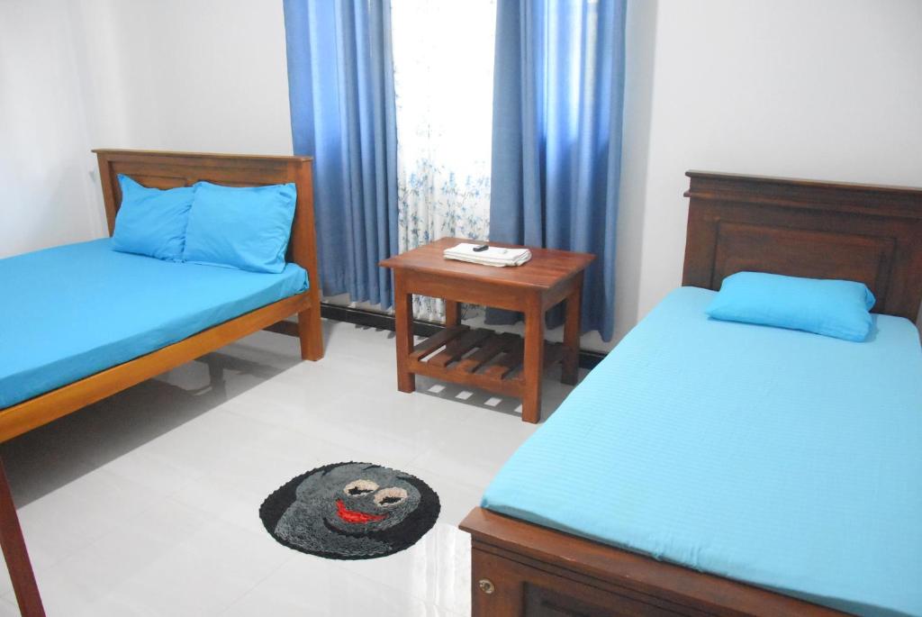 Postel nebo postele na pokoji v ubytování Silverline Guest House Anuradhapura