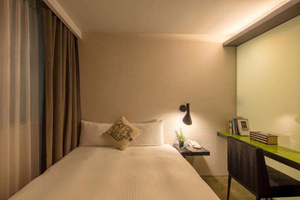 Postel nebo postele na pokoji v ubytování Finders Hotel-Fu Qian