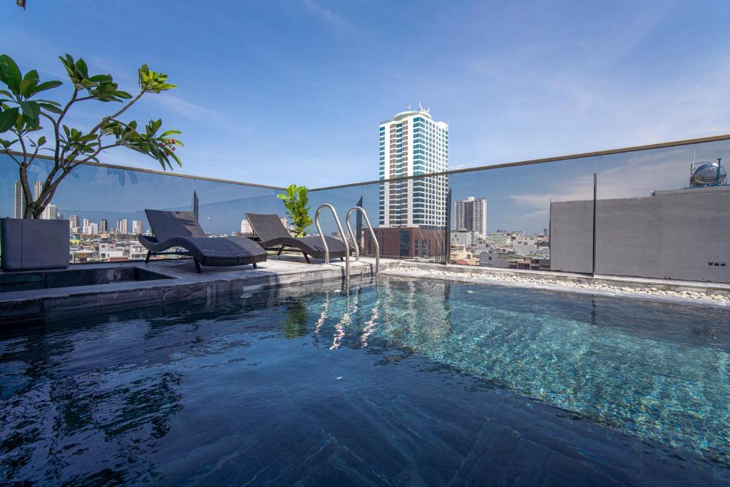 a swimming pool on the roof of a building at HSuites Riverside Hotel and Apartment in Danang