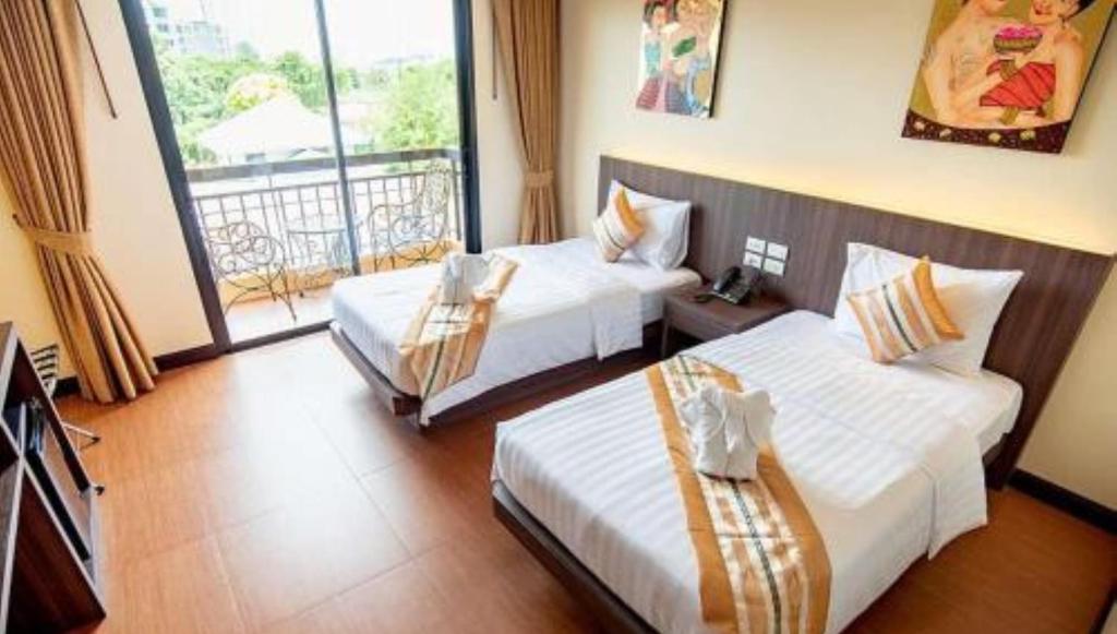 Postel nebo postele na pokoji v ubytování The LD Pattaya Hotel