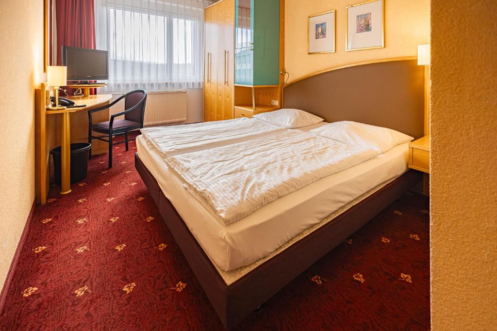 Postel nebo postele na pokoji v ubytování Ringberg Hotel