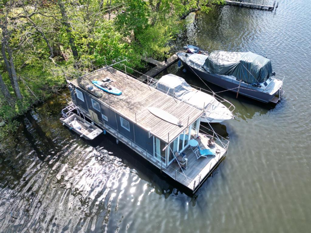 two boats are docked at a dock in the water at Floating Home Valentinswerder in Berlin