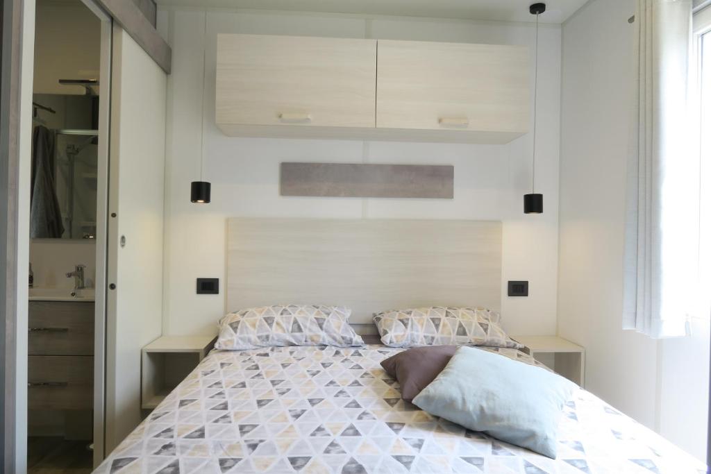 A bed or beds in a room at Camping Adriatico