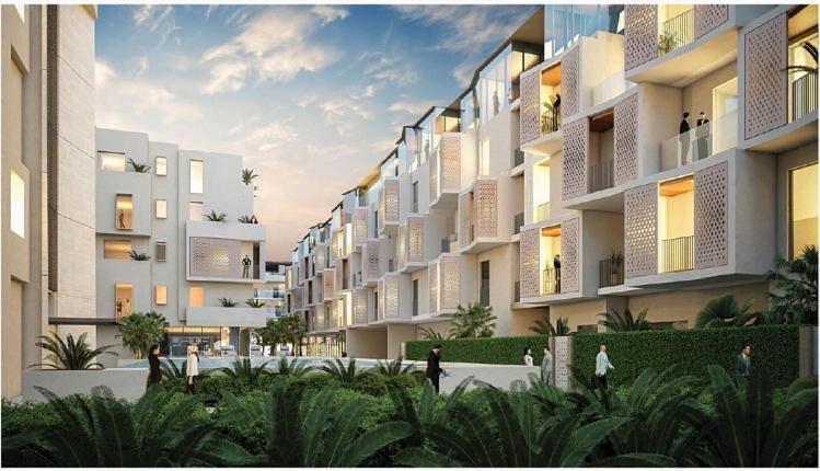 a large building with people walking in front of it at #54 High End 2BR in Mirdif hills in Dubai
