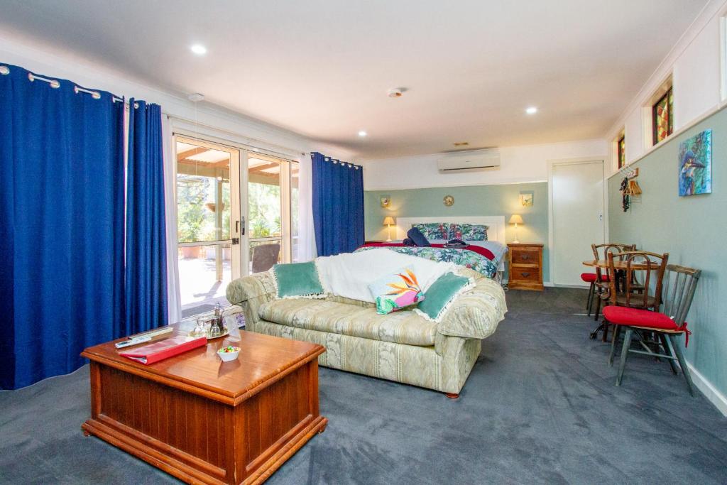 a living room with a couch and a table at Pecan Hill BNB in Toodyay