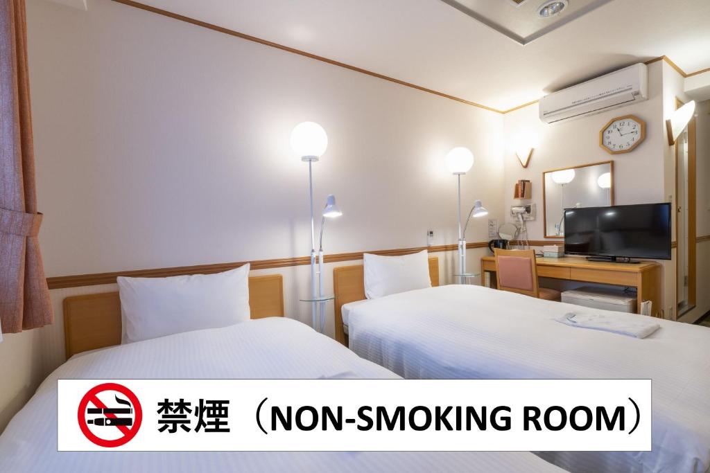 Postel nebo postele na pokoji v ubytování Hotel Endear Gifu
