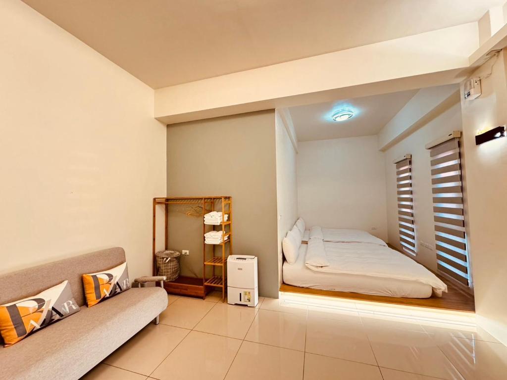 een kleine slaapkamer met een bed en een spiegel bij Xu Xu Homestay in Chiayi City