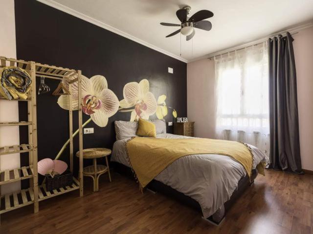 a bedroom with a bed and a ceiling fan at Reade homes in Luton