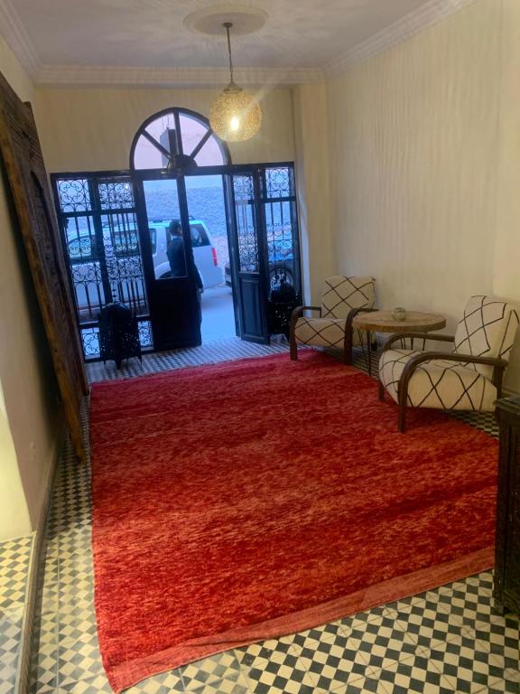 a room with a red rug in front of a door at Hotel Riad Taroudant in Taroudant