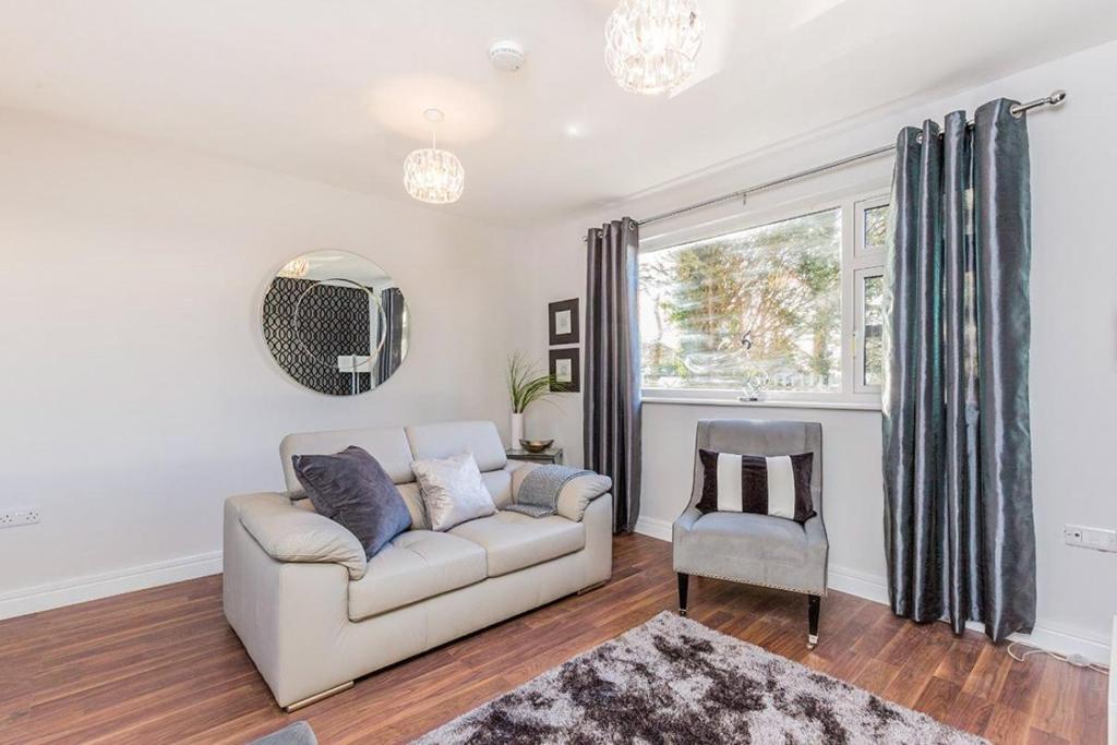 a living room with a couch and a chair at K Suites - Station Road in Hinckley