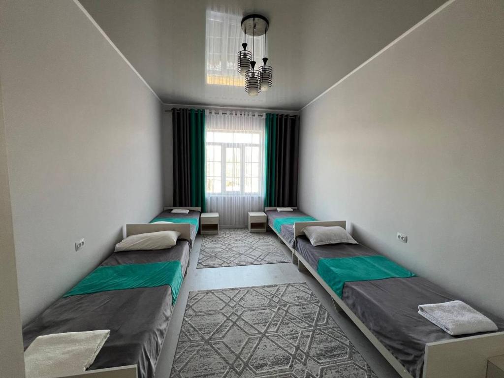 A bed or beds in a room at Гостевой дом Дастан, Guest House Dastan