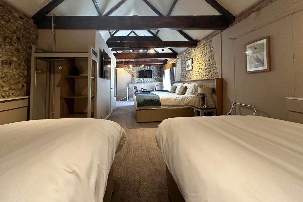 a bedroom with two beds and a room with a bed sqor at The Lobster in Sheringham