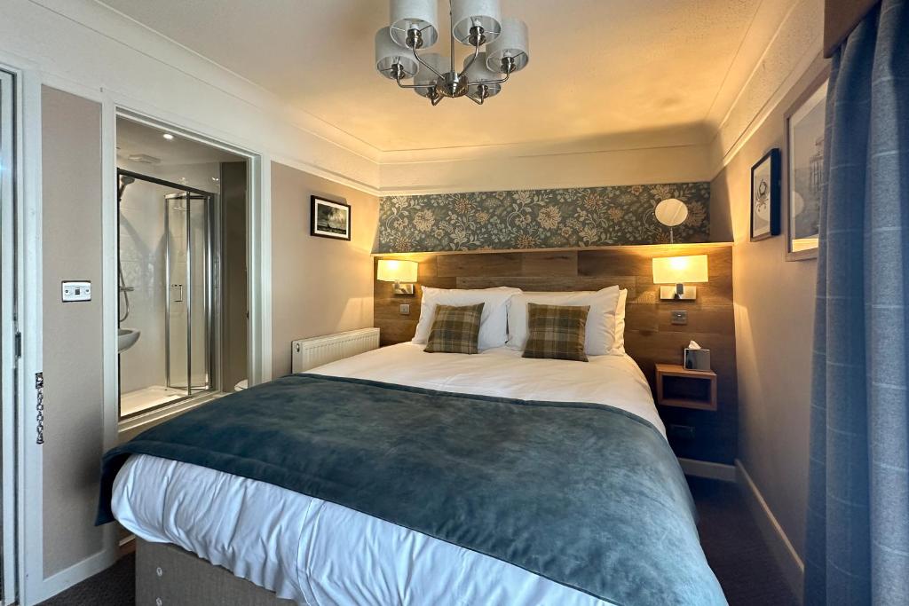 a bedroom with a large bed and a window at The Lobster in Sheringham