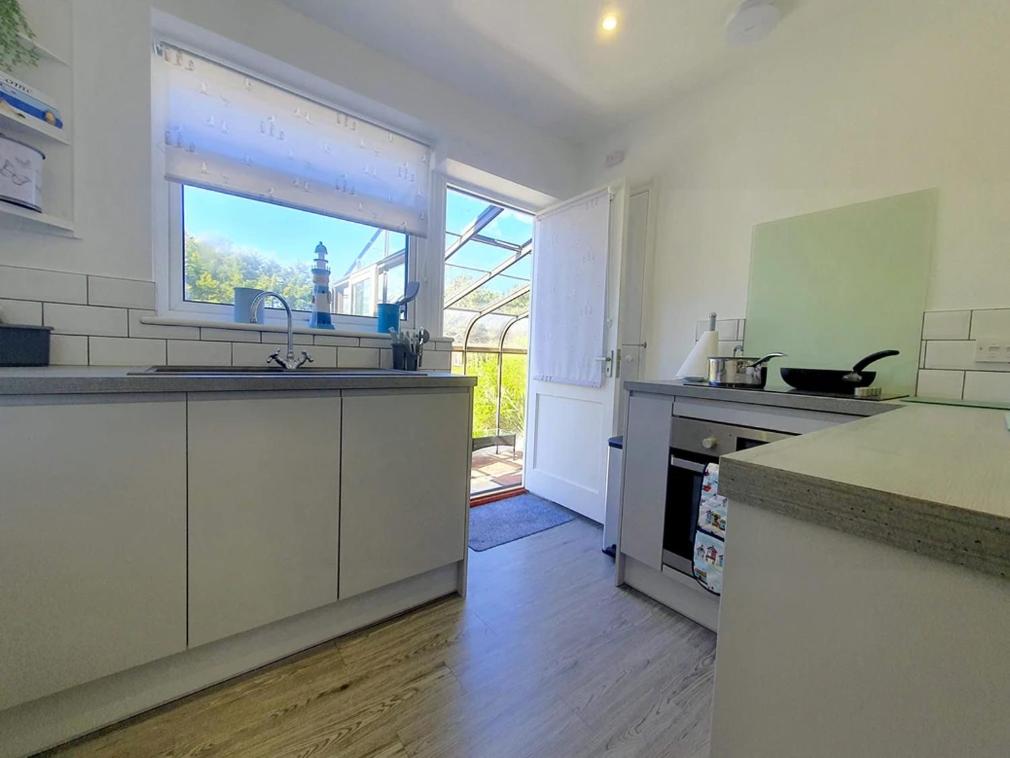 a kitchen with a sink and a counter top at Sea Shells in Greatstone