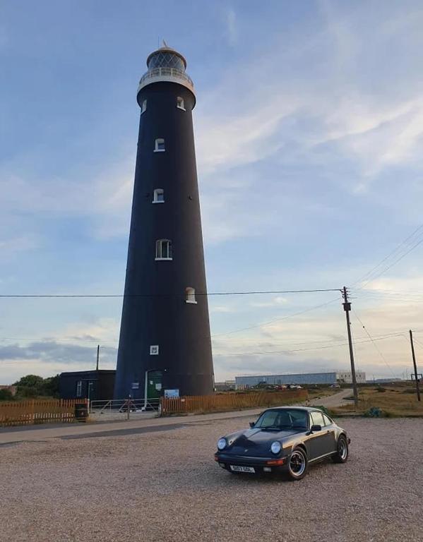 a car parked in front of a lighthouse at Sea Shells in Greatstone