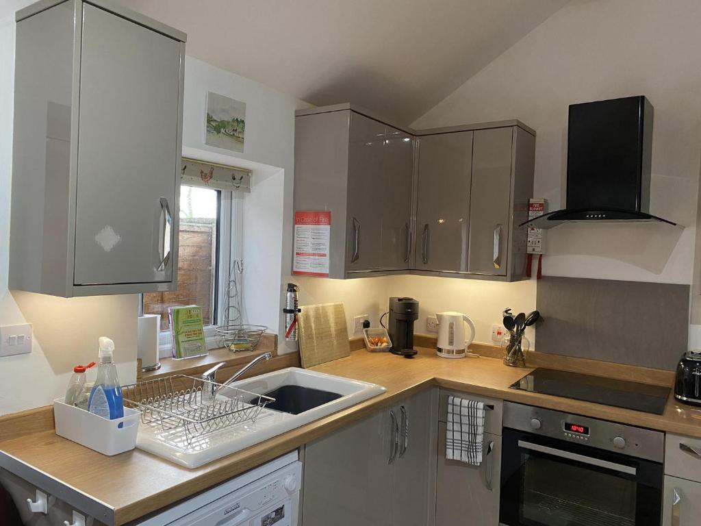 a kitchen with a sink and a counter top at 2 bedroom Holiday home in Norfolk private field in Wisbech