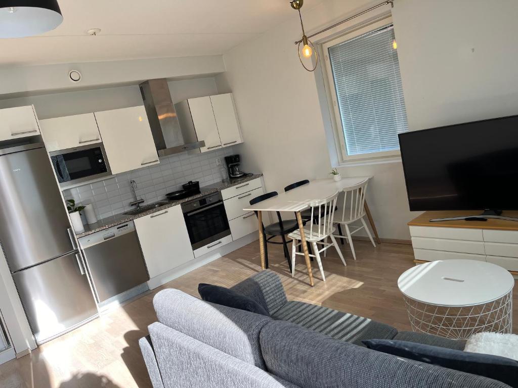 a kitchen and living room with a couch and a table at Riverside cozy flat in Porvoo in Porvoo