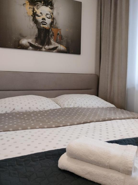 a bedroom with a bed with two towels on it at Apartament 8 Piętro self check-in, parking in Rzeszów
