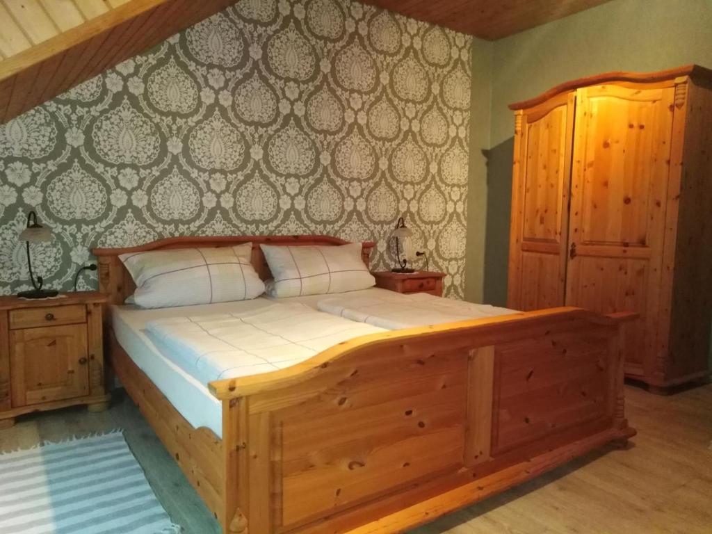 1 dormitorio con cama de madera y pared en Haus Berger en Seebach