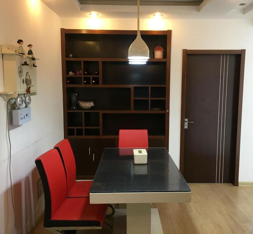 a dining room with a table and red chairs at 雅伦之屋 Yailon Aparment in Nanjing