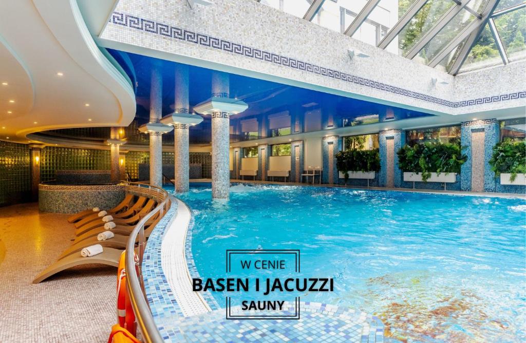 a large swimming pool in a hotel lobby at Haffner Hotel & SPA Sopot in Sopot