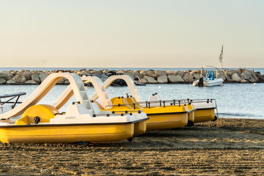 a group of yellow boats parked on the beach at Lordos Beach Hotel & Spa in Larnaca
