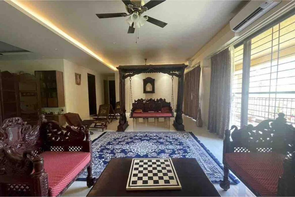 a living room with a chess board on a rug at Endora homestay - A fully equipped lake-facing 3BHK in Lavasa