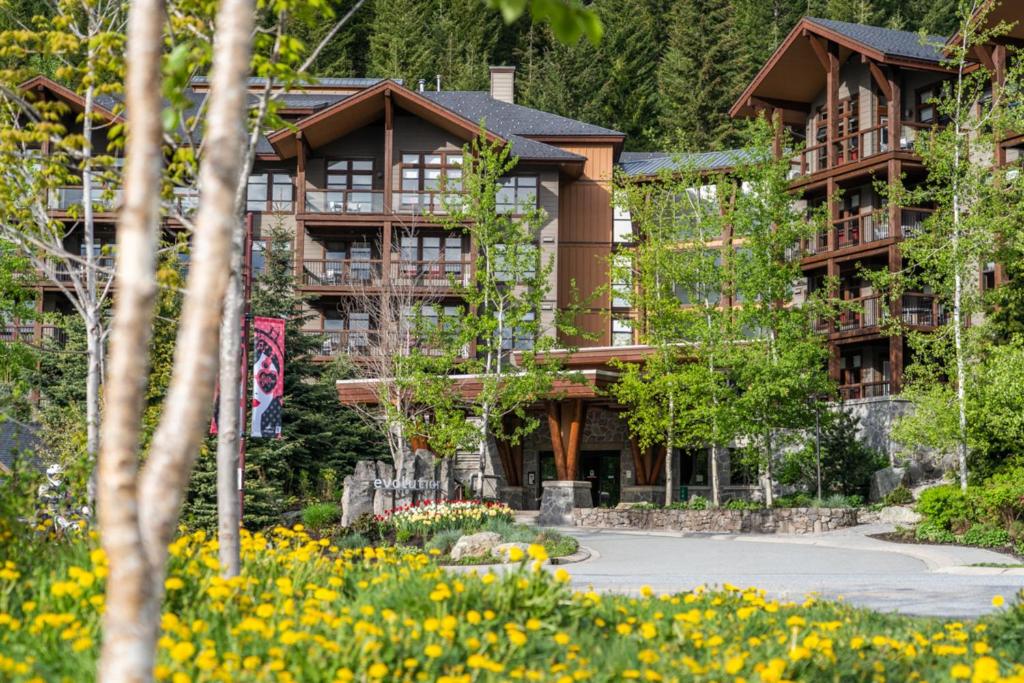a resort building with flowers in front of it at Evolution Whistler in Whistler