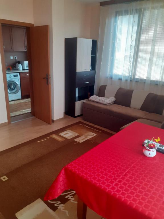 a living room with a couch and a red table at Apartment Ceco in Troyan