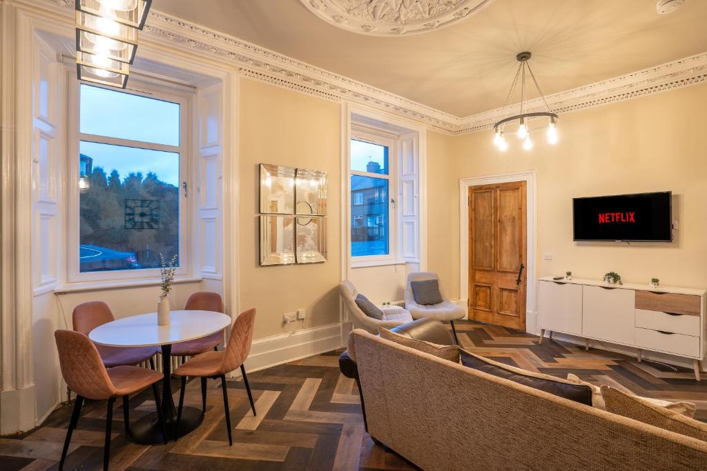 a living room with a couch and a table at Stylish 2 Bed Flat-Free Parking in Arniston
