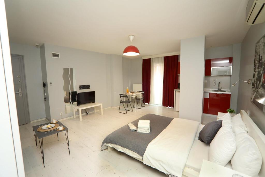 a bedroom with a large bed and a kitchen at Arkem Hotel 1 in Istanbul