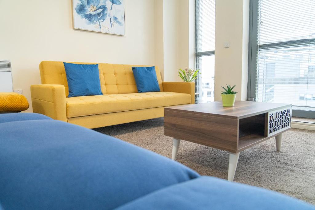 a living room with a couch and a coffee table at Stay in our Stylish Flat! & secure building & sleeps up to 4 in Birmingham