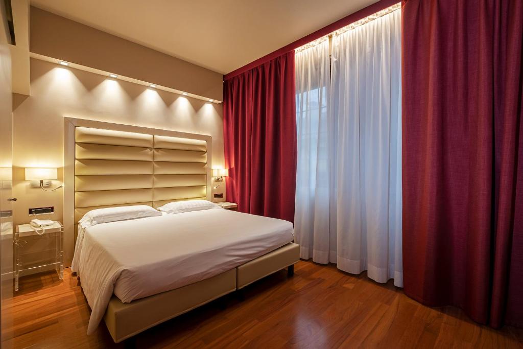 Postel nebo postele na pokoji v ubytování Hotel Touring