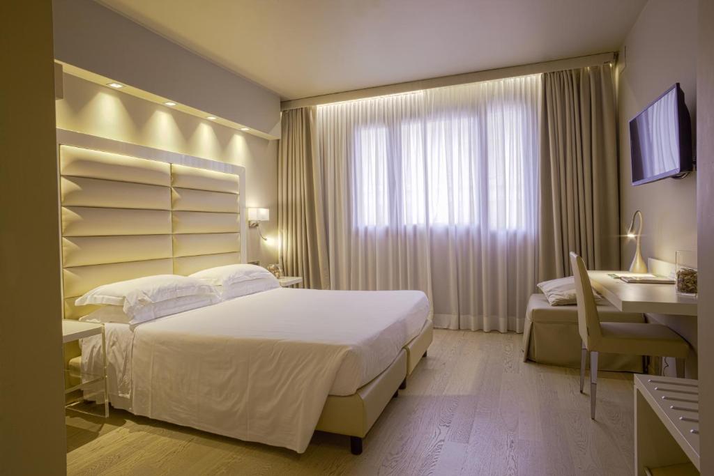 Postel nebo postele na pokoji v ubytování Hotel Touring