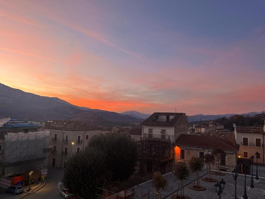 a sunset over a city with buildings and mountains at La Casa di Garibaldi in San Demetrio neʼ Vestini