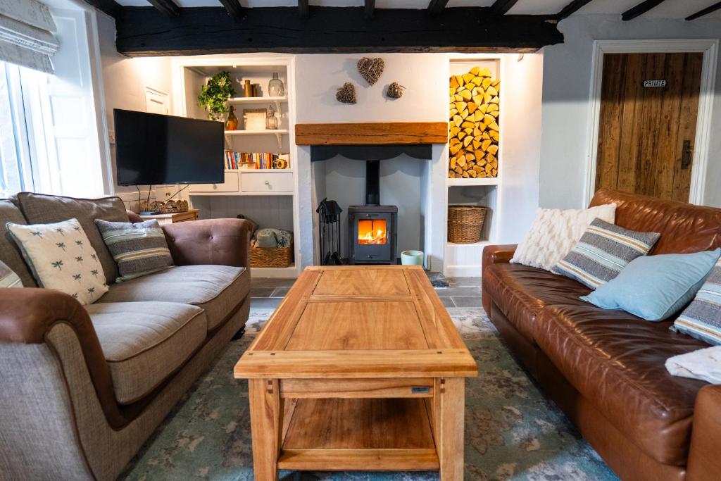 a living room with a couch and a fire place at Cottage On The Brook in Keswick