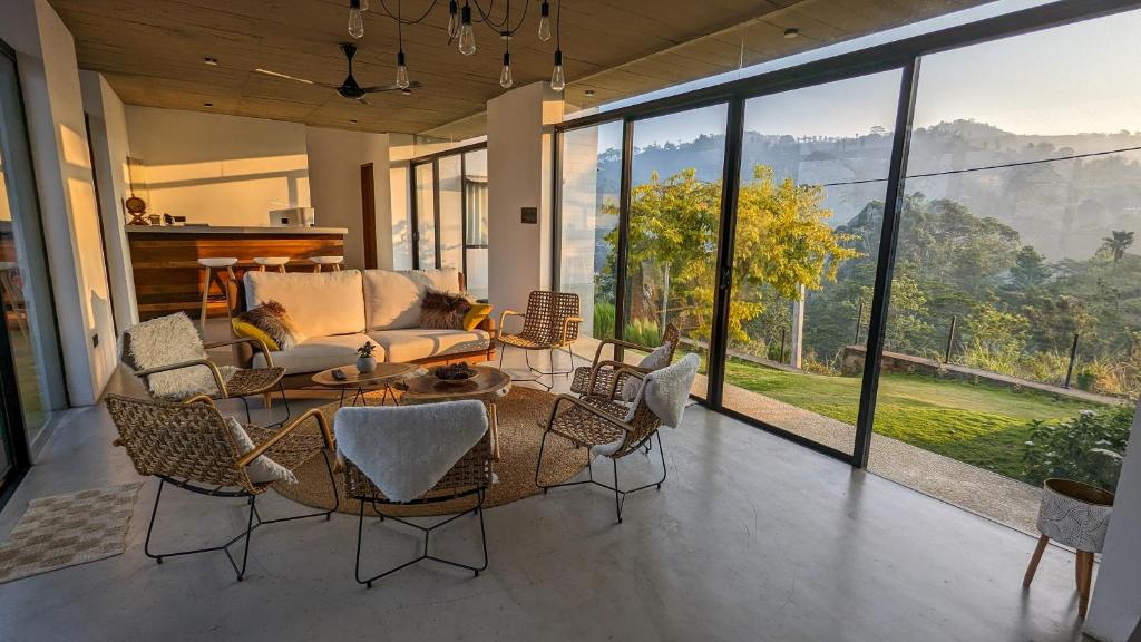 a living room with a couch and a table and chairs at Misty Villa Powered by TSC in Pussellawa
