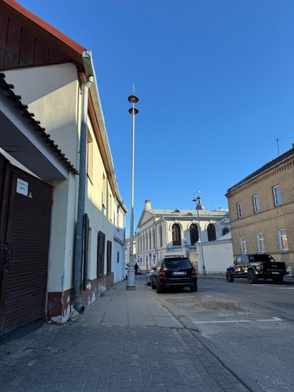 a street with a building and a car parked on the street at Tilto 6 in Vilnius