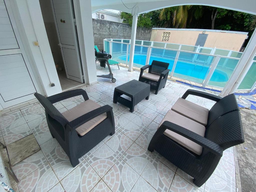 a patio with furniture and a swimming pool at UN PLONGEON A la DEMEURE MOCENEA in Richemont