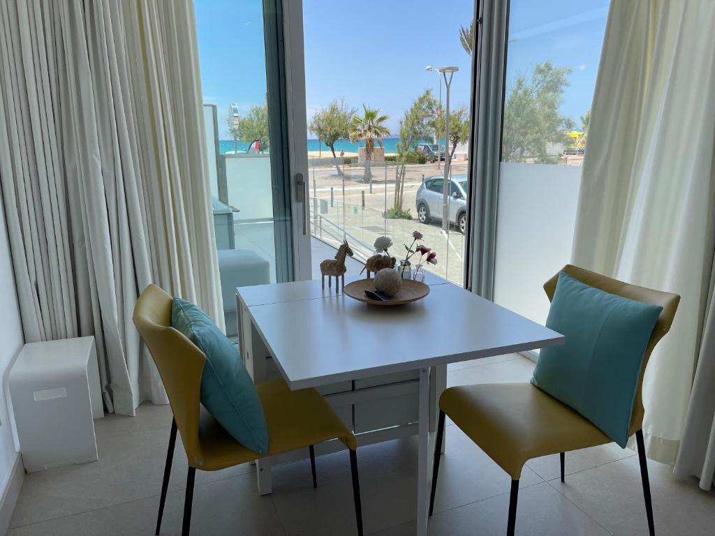 a dining room with a table and chairs and a window at The Hype Beachhouse in Playa de Palma