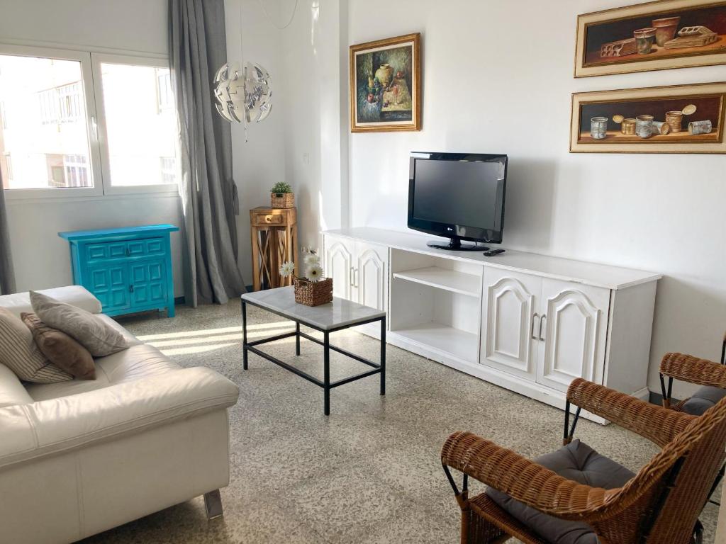 uma sala de estar com um sofá e uma televisão em Nestor de la Torre I by Canary365 em Las Palmas de Gran Canaria