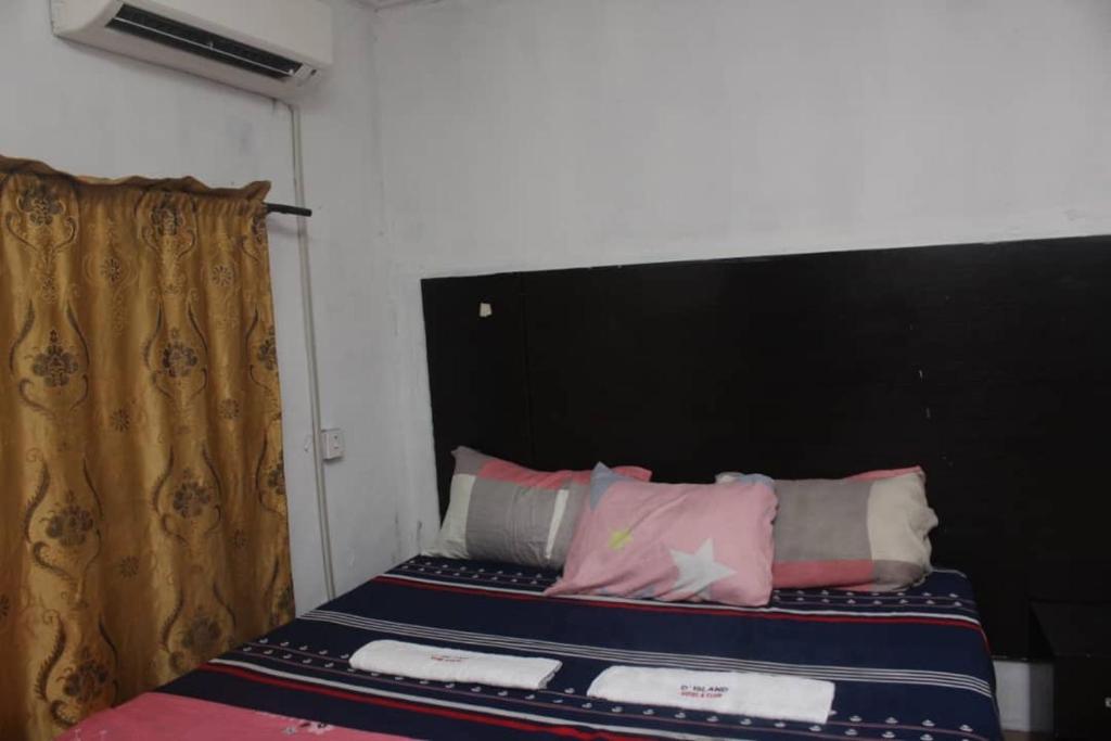 a bed with a black headboard in a room at D’ ISLAND AND CLUB HOTEL in Lekki