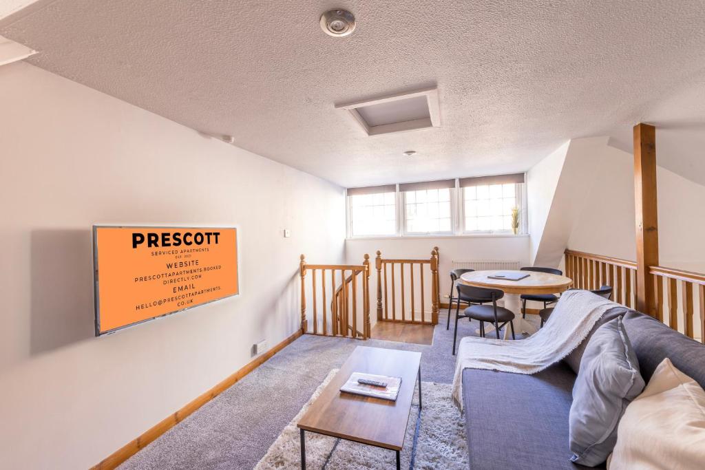 a living room with a couch and a table at Complete Admiralty Terrace with FREE PARKING by Prescott Apartments in Bristol