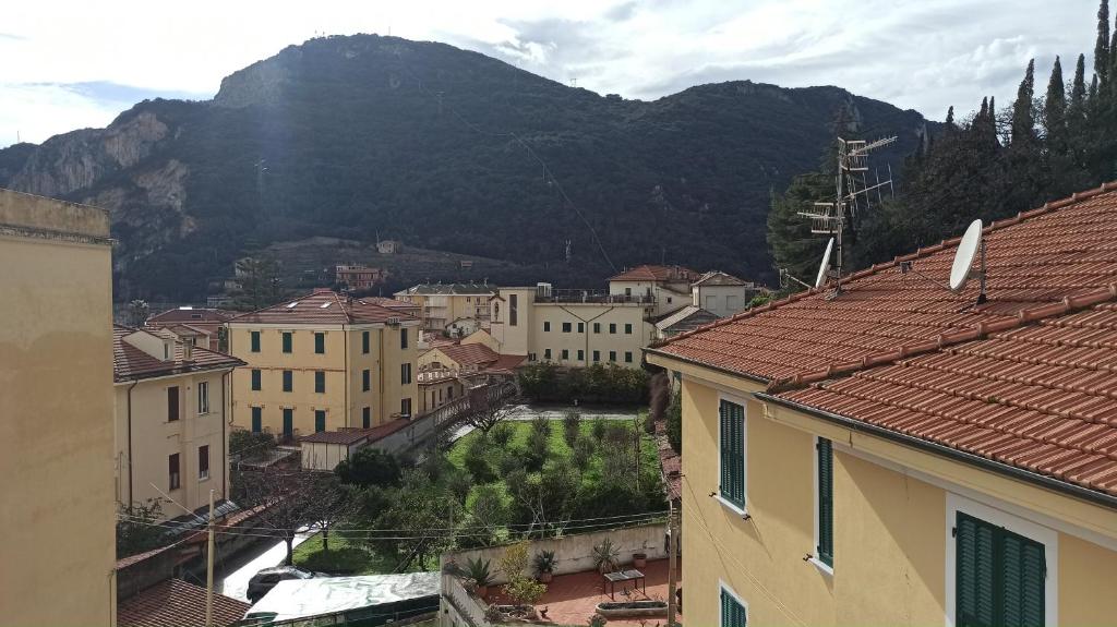 een stad met gebouwen en een berg op de achtergrond bij Host Riviera in Finale Ligure