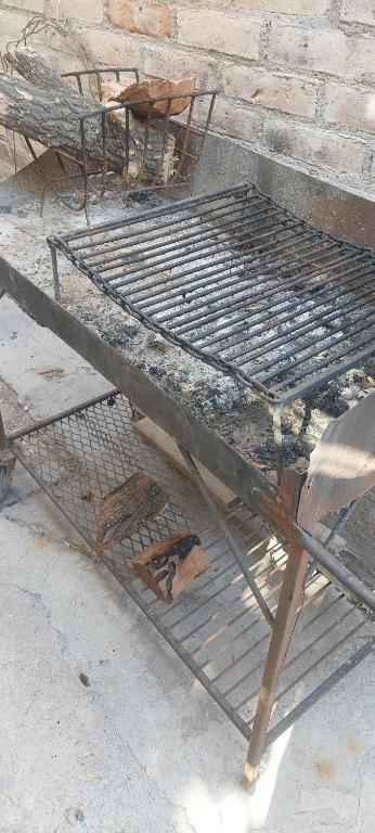 an old metal bed sitting on the ground at Kaizen in Mendoza