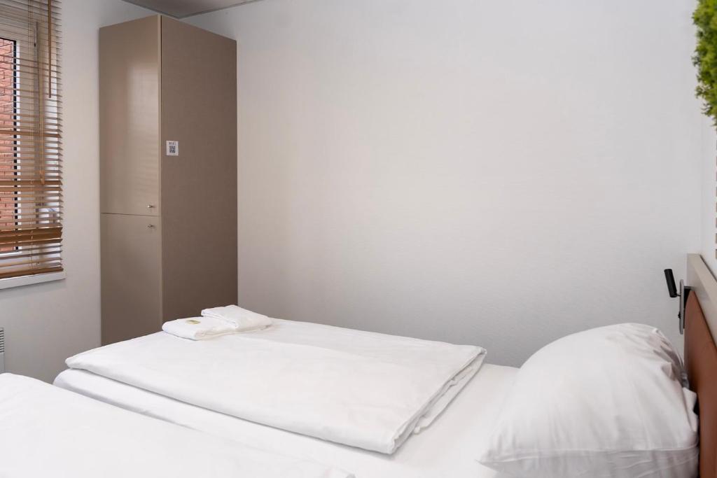 Ein Bett oder Betten in einem Zimmer der Unterkunft Comfort Housing Apartments