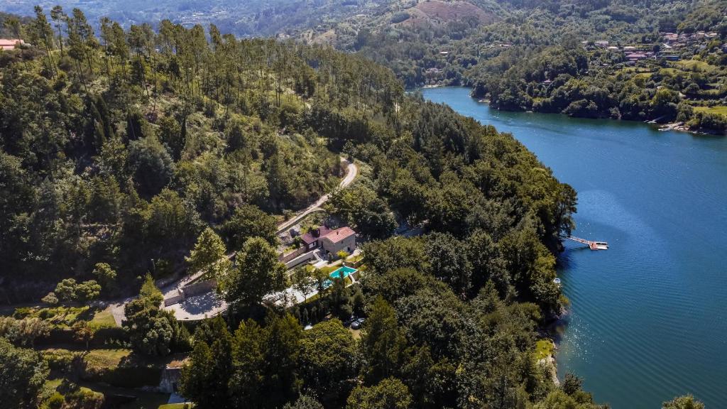 an aerial view of a house on a island in a lake at Casa da Cascata in Geres