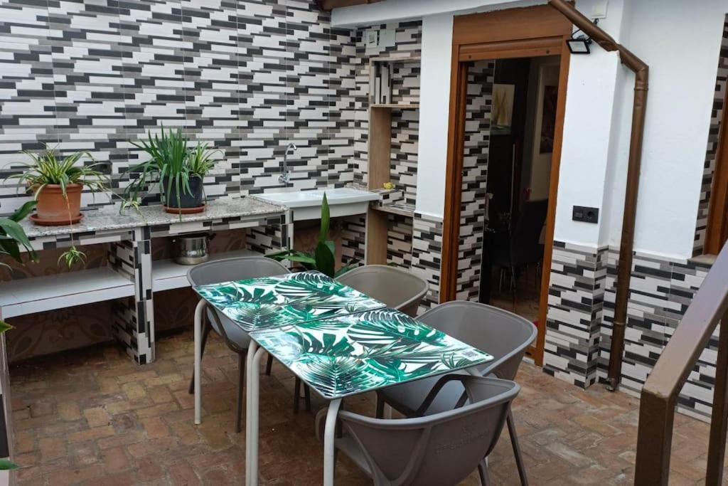 a patio with a table and chairs and plants at Casa preciosa con vistas in Granada